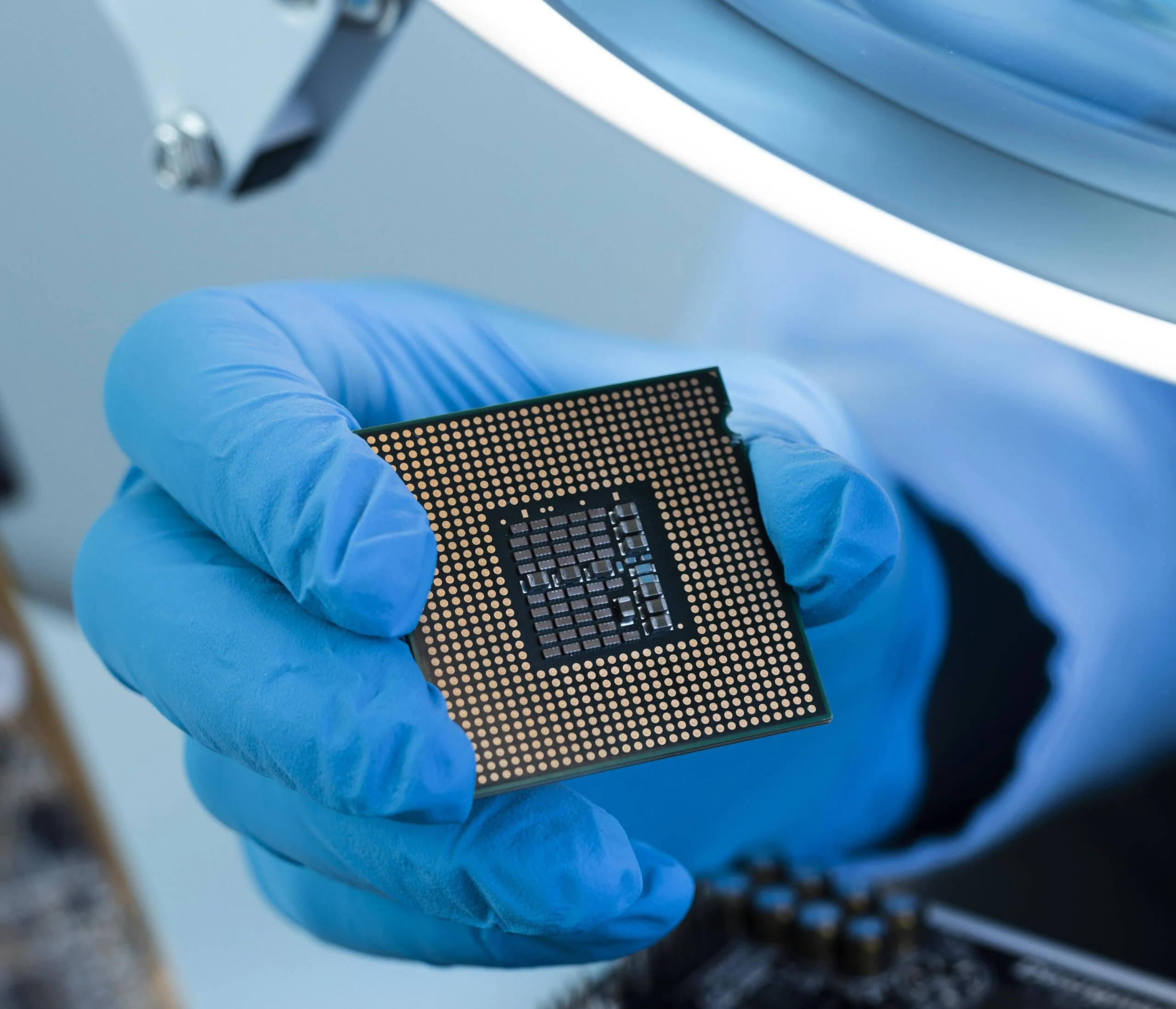 Gloved hand holding a microchip