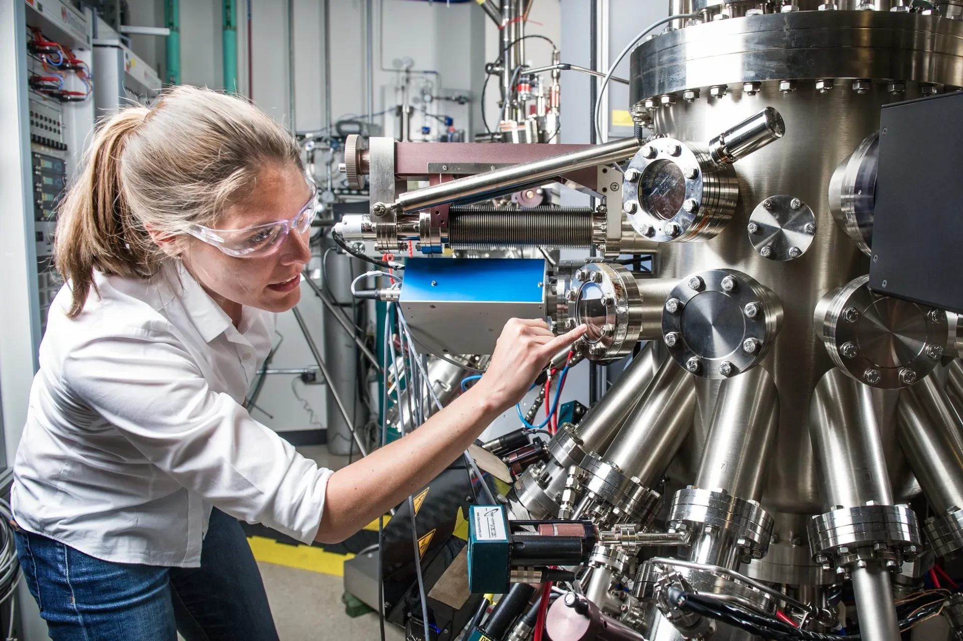 Engineer adjusting manufacturing equipment in a laboratory