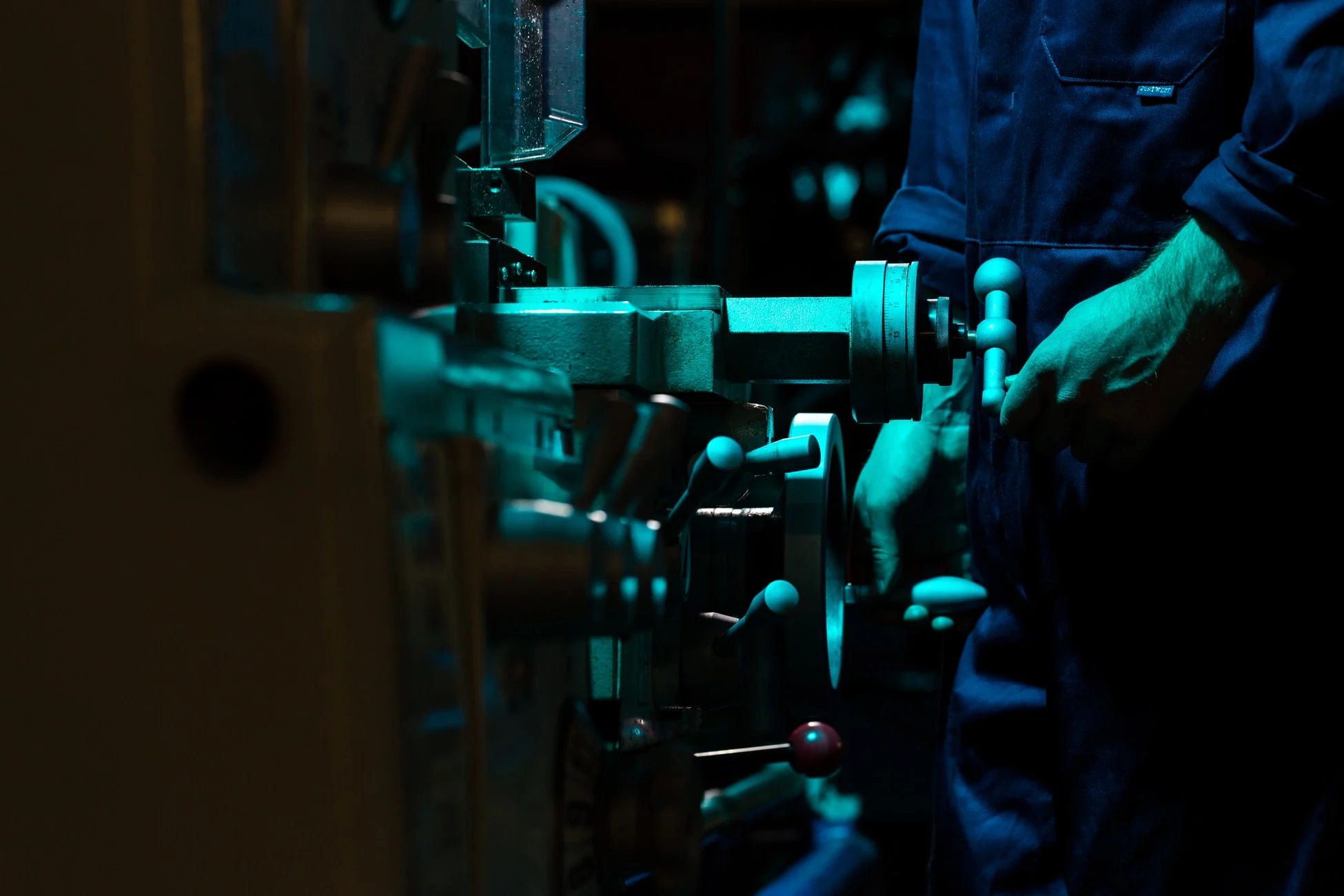 Worker operating industrial equipment on a factory floor