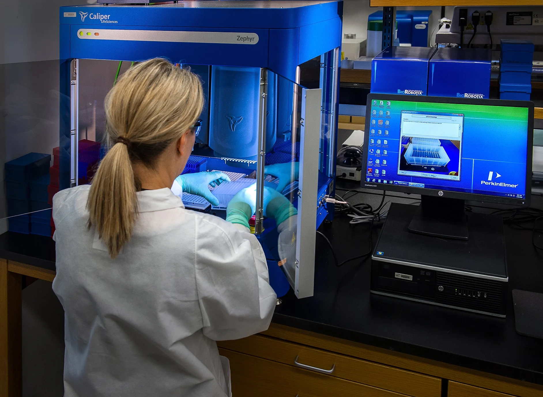 Laboratory technician using automated testing equipment