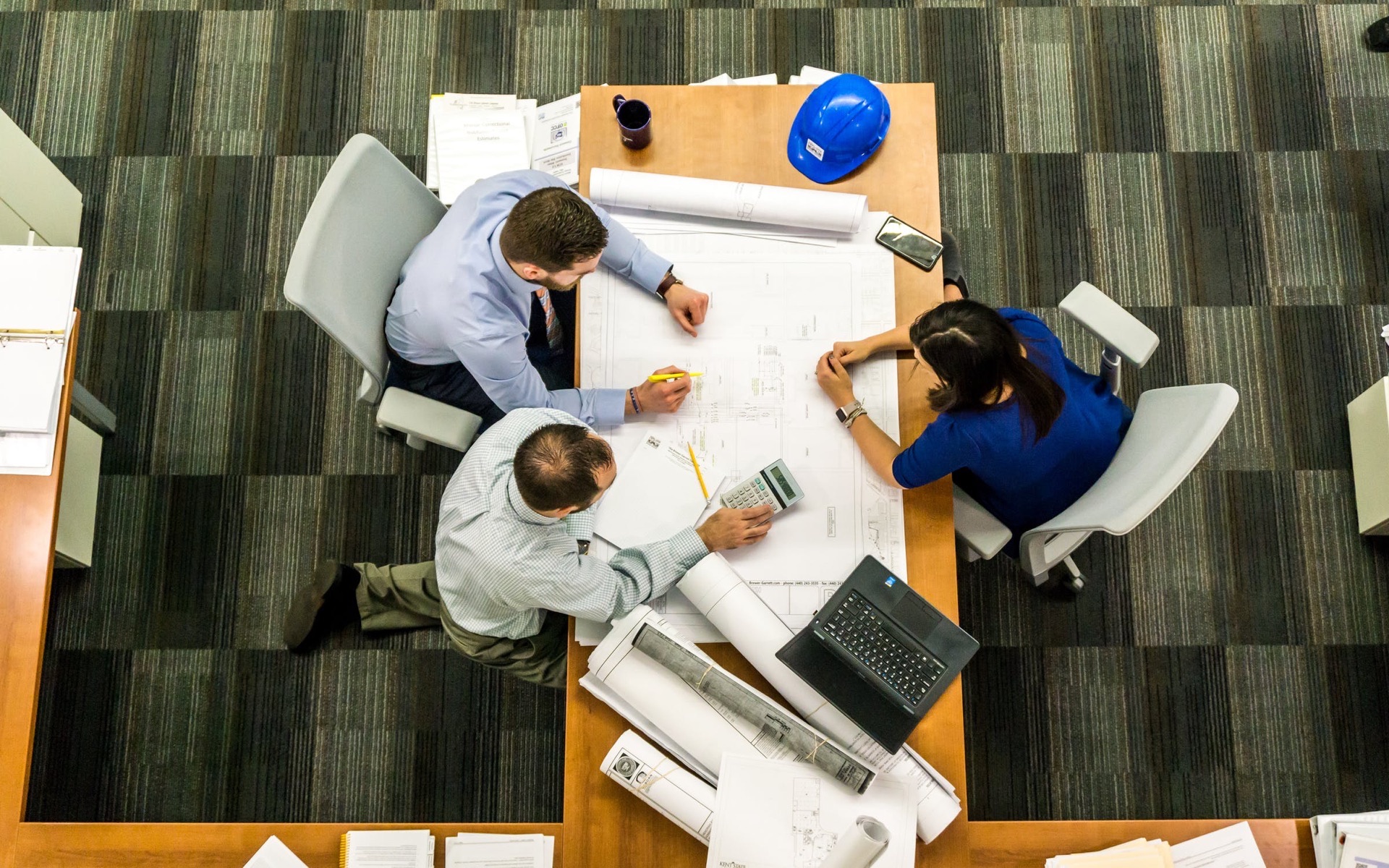 Team reviewing plans around a table