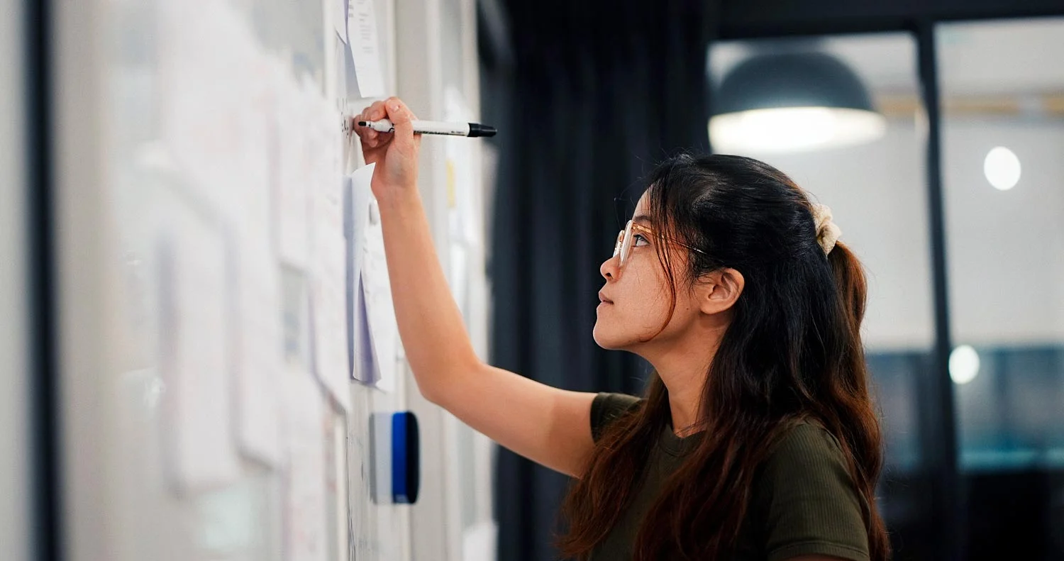 Professional writing on a transparent planning board