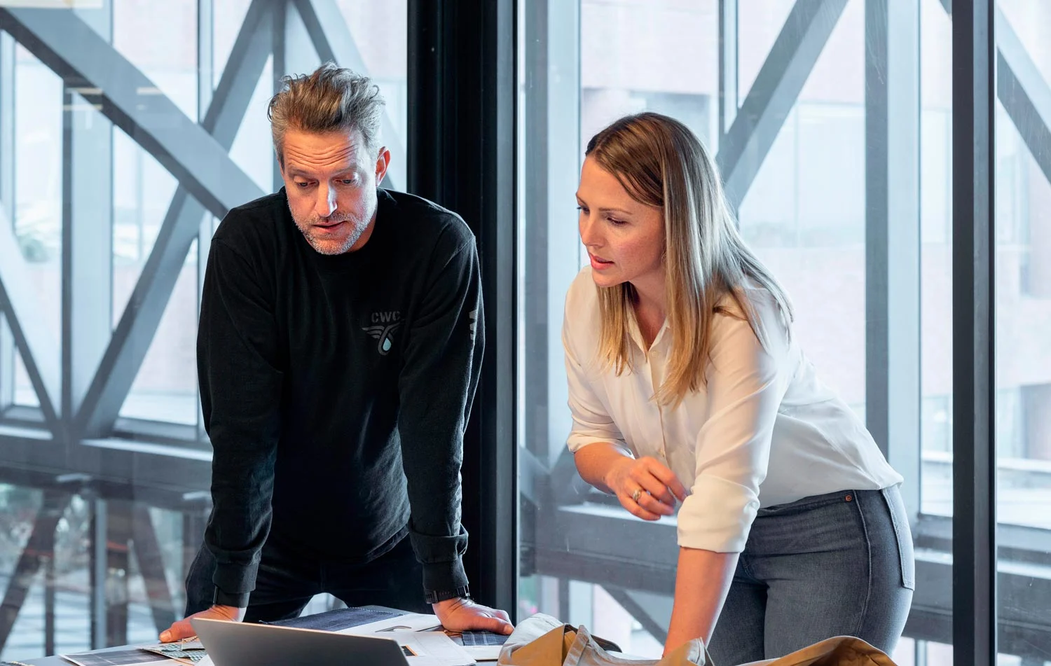Two colleagues reviewing a value stream map