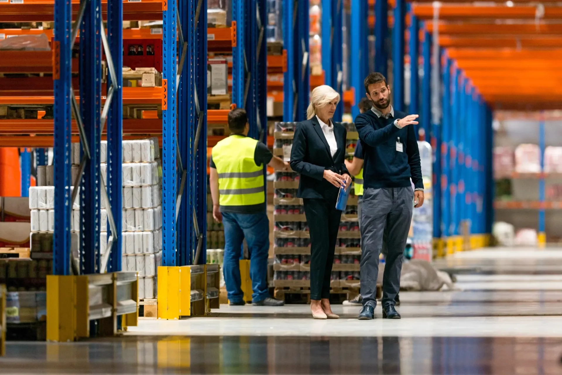 A pair of lean consultants auditing the floor of a smart warehousing facility